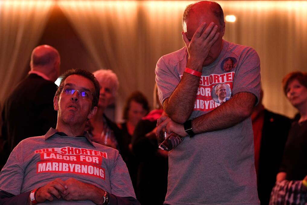 Labor supporters watch the tally count at the federal Labor reception in Melbourne. Picture: AAP Image/Lukas Coch