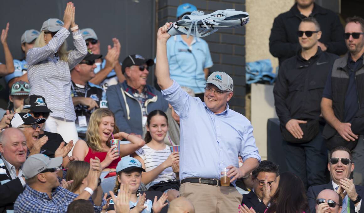 Prime Minister Scott Morrison waves to the crowd during a Cronulla Sharks match. Picture: AAP