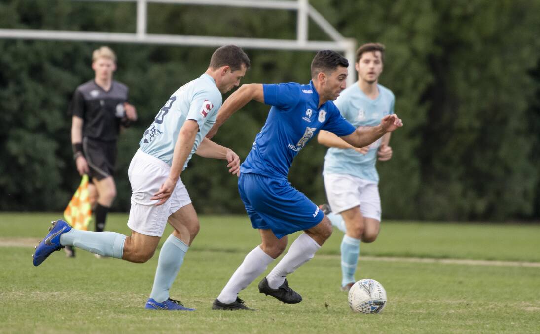 Belconnen United's Izach Clements, left, attempts to shutdown Canberra Olympic's Stephen Domenici. Picture: Sitthixay Ditthavong