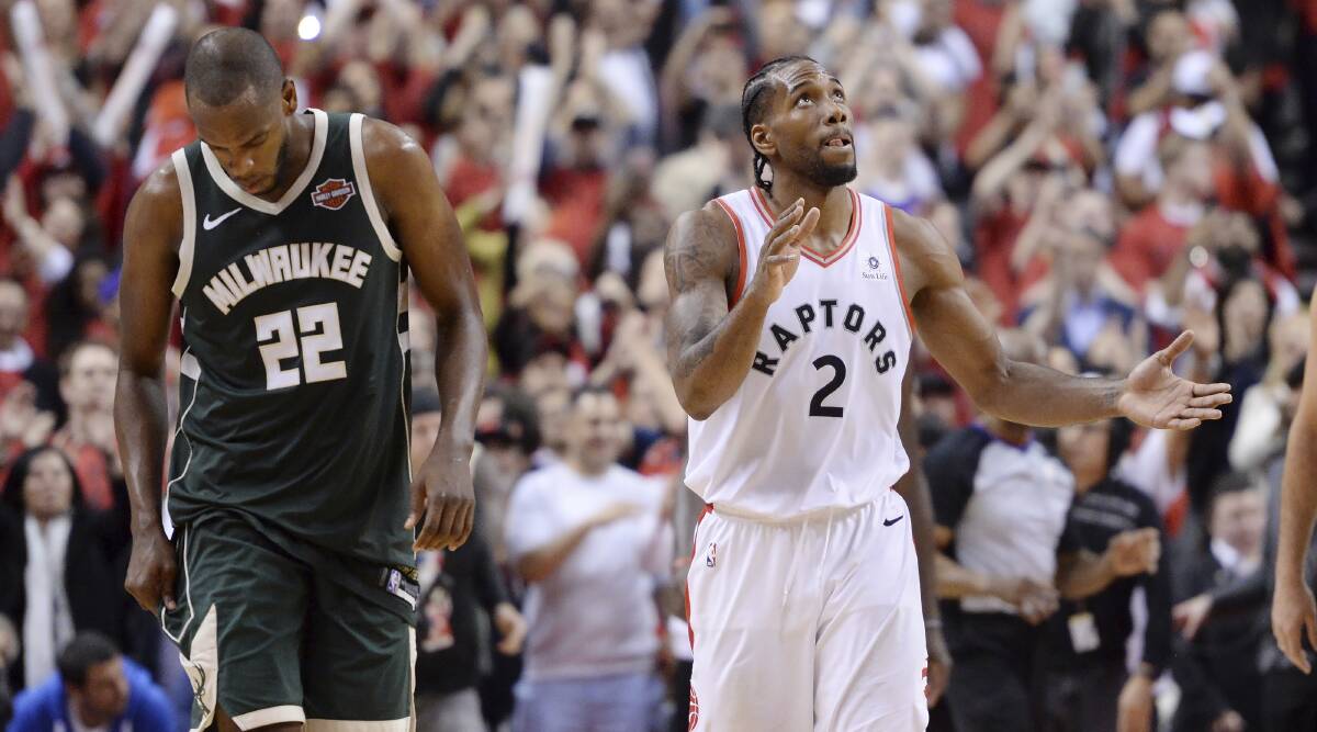 Toronto Raptors forward Kawhi Leonard (2) reacts as Milwaukee Bucks forward Khris Middleton (22) looks on following the Raptors' win game three of the NBA basketball playoffs Eastern Conference finals in Toronto on Monday (AEST). Picture: AP