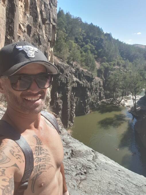 Jarrad Teka moments before falling down the Ginninderra Falls. The two people who saved him are swimming below. Picture: Supplied