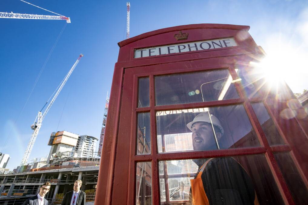 Geocon's Kristoff Penc in the London phone box at the Republic construction site in Belconnen. Picture: Sitthixay Ditthavong