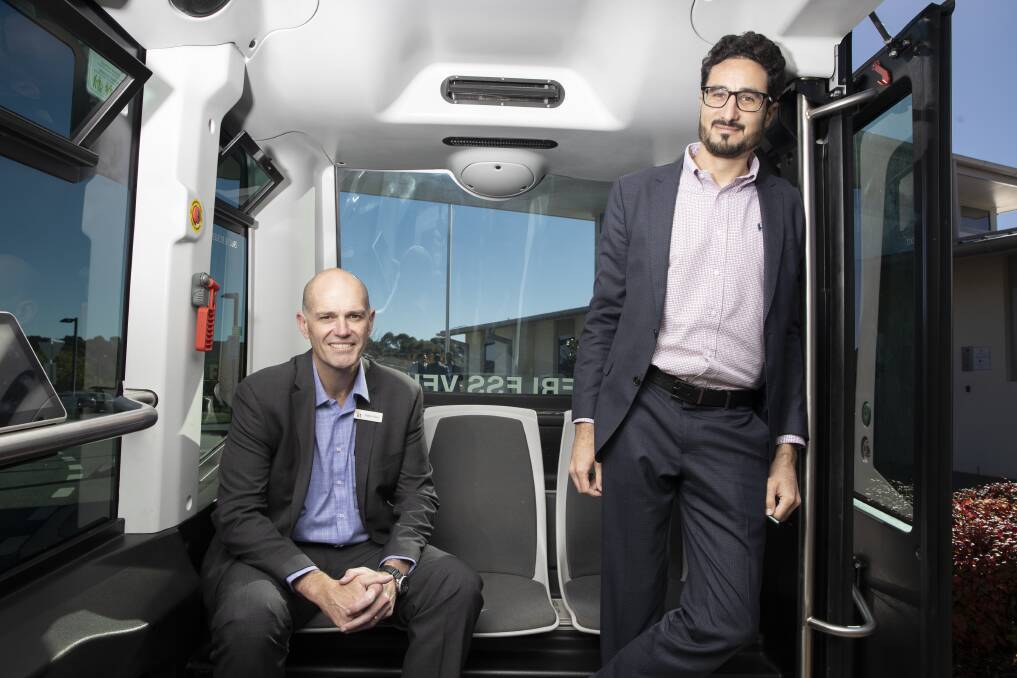 IRT Group CEO Patrick Reid and managing director Greg Giraud in one of their driverless buses being tested at IRT Kangara Waters in Belconnen. Picture: Sitthixay Ditthavong