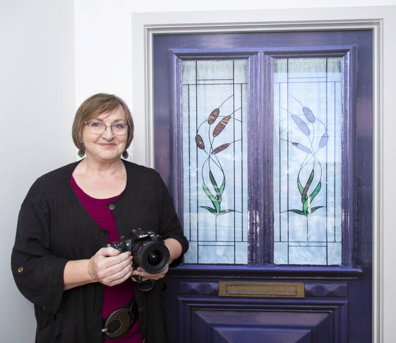 True Doors consultant Carolyne Taplin, pictured with one of the company's door decals. Picture: Shane Carey