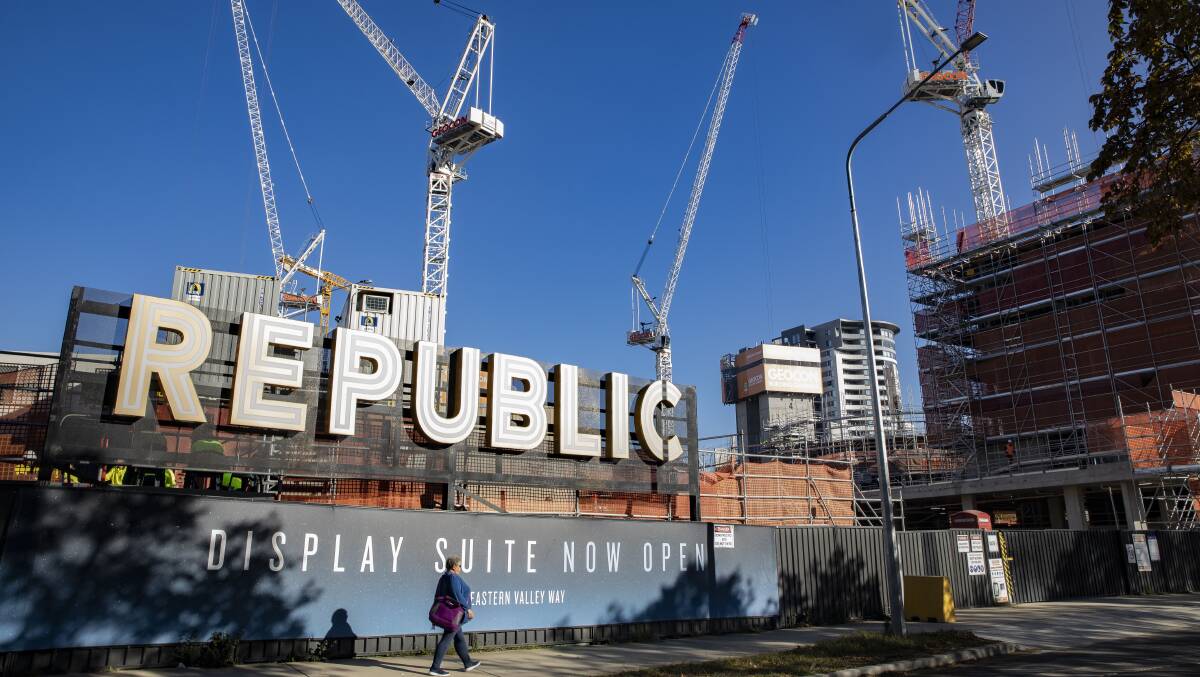 A pedestrian in May walks past the site of the Geocon project Republic in Belconnen. Picture: Sitthixay Ditthavong