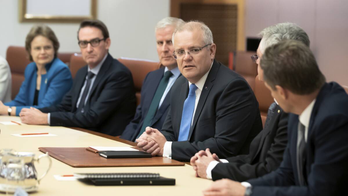 Prime Minister Scott Morrison speaks with departmental secretaries around the cabinet table at Parliament House last week. Picture: Alex Ellinghausen