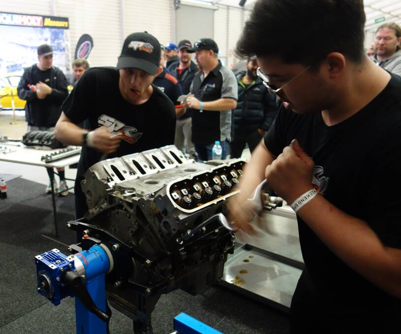 Canberra apprentice mechanics Kyle Macpherson, left, and Oliver Kwong race the clock in the Flying Spanners competition.