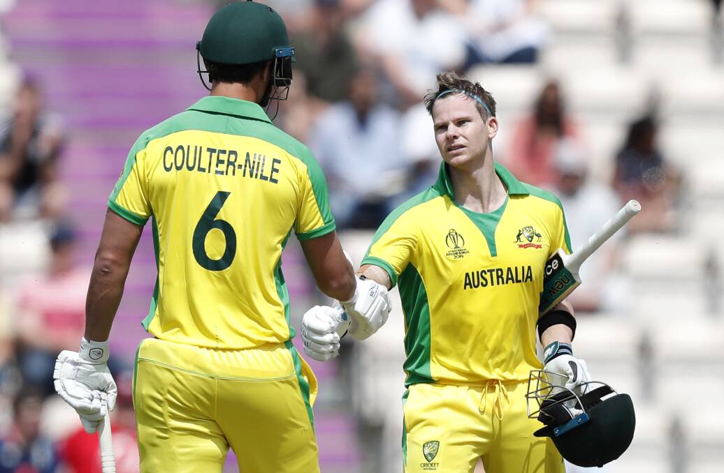 Australia's Steve Smith, right is congratulated by teammate Australia's Nathan Coulter-Nile after scoring 100 runs not out. Picture: AP