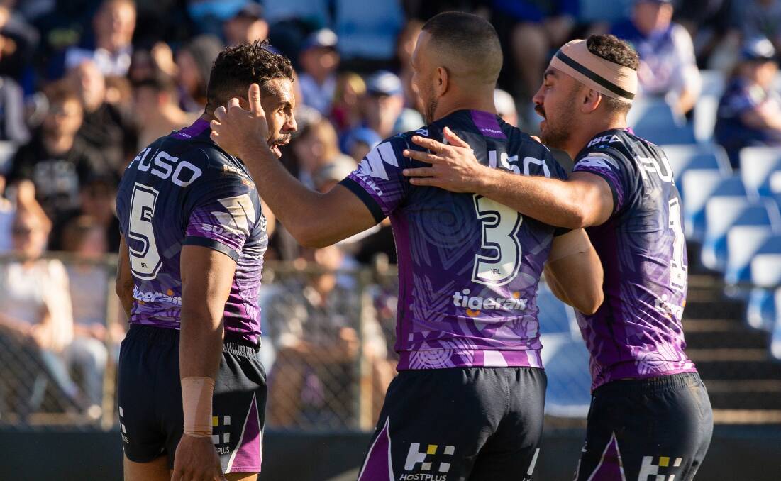 Josh Addo-Carr (left) of the Storm celebrates after scoring. Picture: AAP