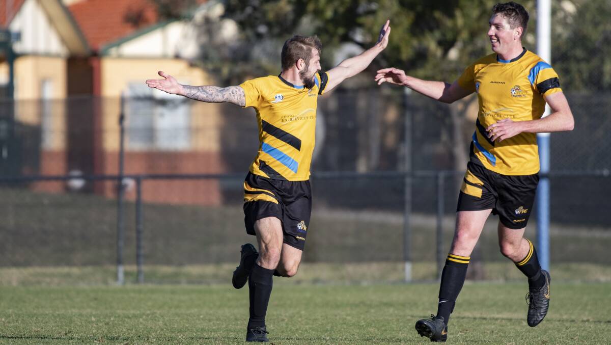 Cooma Tigers' Darren Bailey, left, celebrates their first goal. Picture: Sitthixay Ditthavong