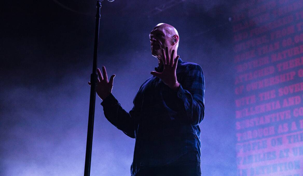  Midnight Oil frontman Peter Garrett with the Statement from the Heart illuminated behind him. Picture: Sitthixay Ditthavong