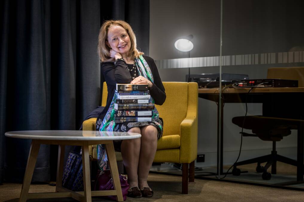 Christine Courtenay, widow of the late Bryce Courtenay at the National Library of Australia with various editions of the book held by the library. Picture: Karleen Minney.