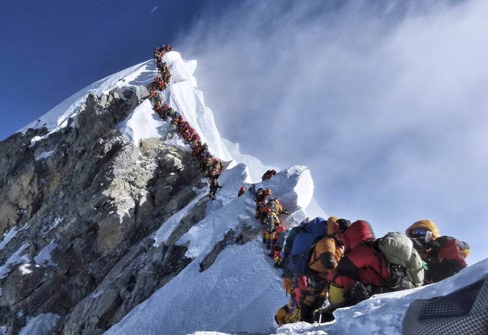 In this photo on May 22, 2019, a long queue of mountain climbers line a path on Mount Everest. There were 11 climbers that died on Everest in 2019, most while descending from the congested summit during only a few windows of good weather each May. Picture: Nimsdai Project Possible via AP