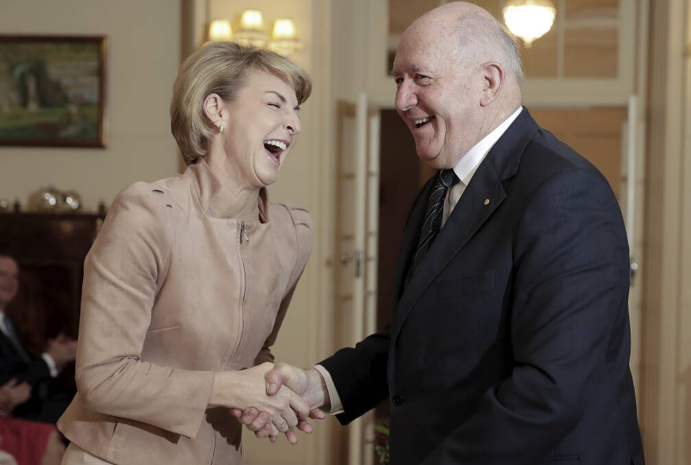 Having a laugh: Michaelia Cash and Sir Peter Cosgrove on the day the error was locked into law. Photo: Alex Ellinghausen