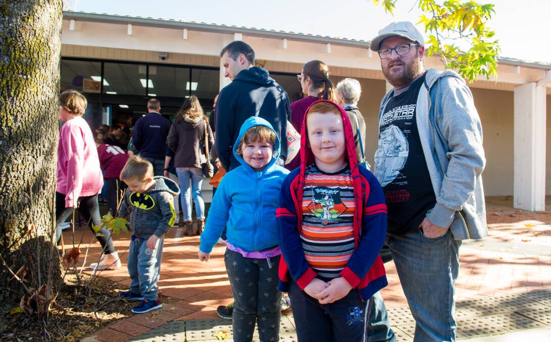 Jessica Brown, 4, Lachlan Brown, 6 and James Brown of Dunlop in the queue outside Network Video in Charnwood, where they hoped to pick up some cheap DVDs. Picture: Elesa Kurtz