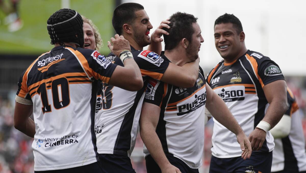 The Brumbies celebrate Connal McInerney's, centre, three tries against the Sunwolves last week. Picture: AP