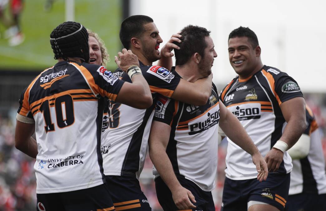 Brumbies hooker Connal McInerney, centre, scored a hat-trick when he came off the bench. Picture: AP Photo/Jae C. Hong