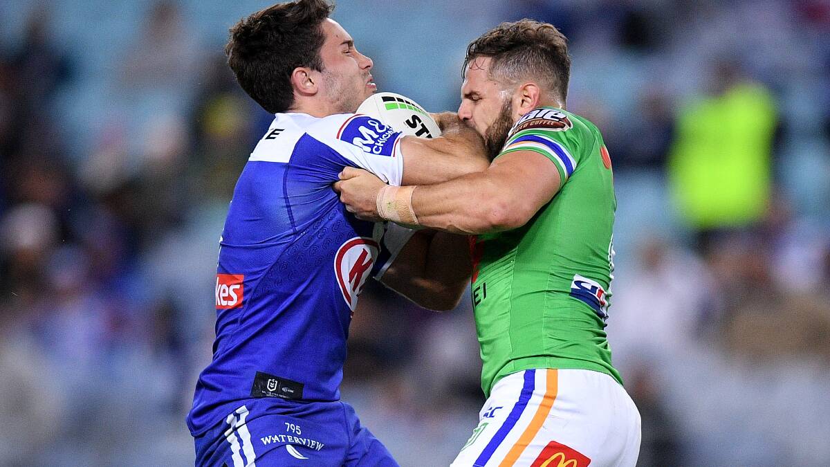 Nicholas Meaney of the Bulldogs is tackled by Aiden Sezer of the Raiders during the Round 12 NRL match between the Canterbury Bankstown Bulldogs and the Canberra Raiders at ANZ Stadium in Sydney, Saturday, June 1, 2019. (AAP Image/Dan Himbrechts) NO ARCHIVING, EDITORIAL USE ONLY
