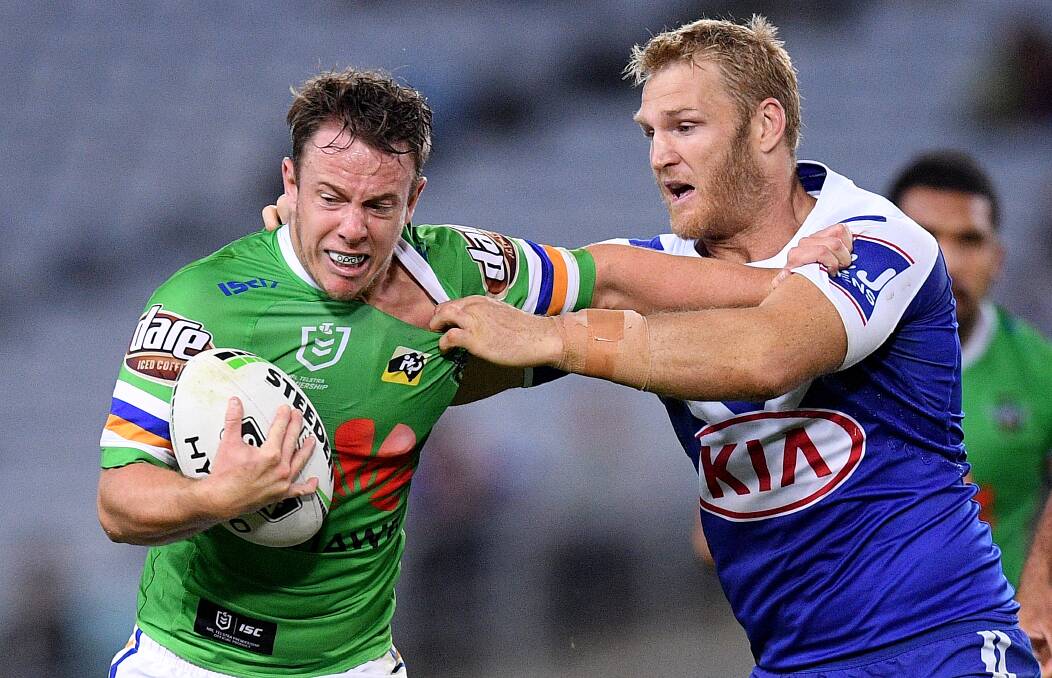 Sam Williams of the Raiders is tackled by Aiden Tolman of the Bulldogs on Saturday. Picture: AAP