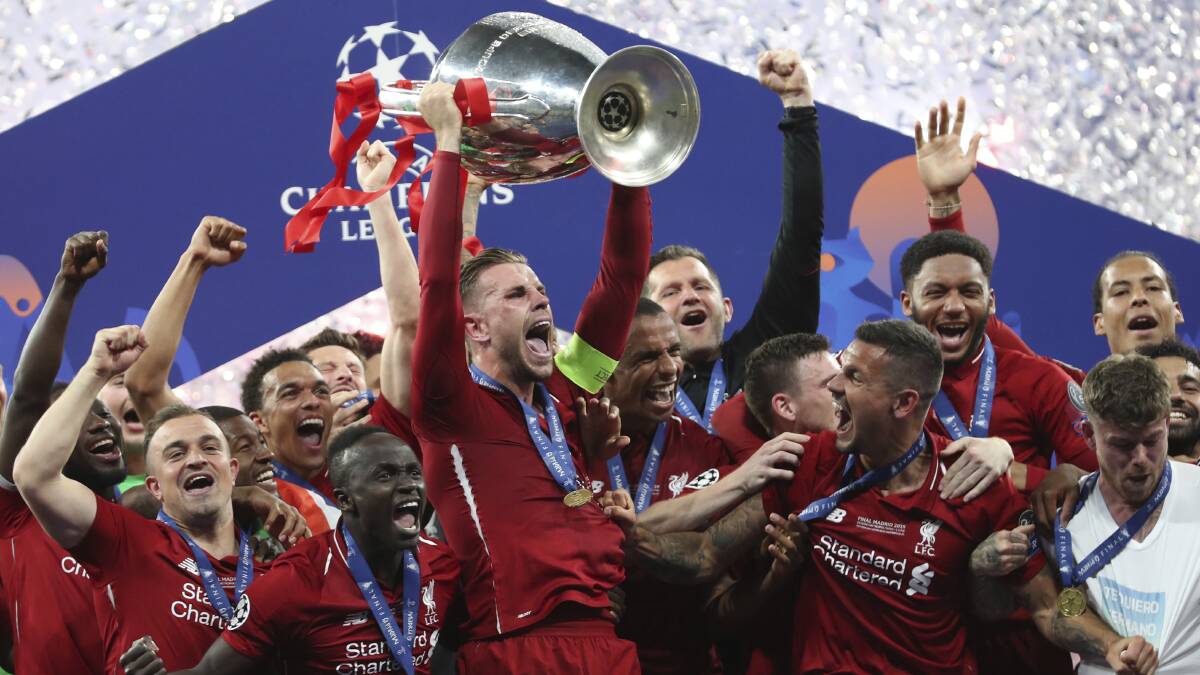 Liverpool's Jordan Henderson lifts the trophy to celebrate with his teammates winning the Champions League final soccer match between Tottenham Hotspur and Liverpool. Picture: AP