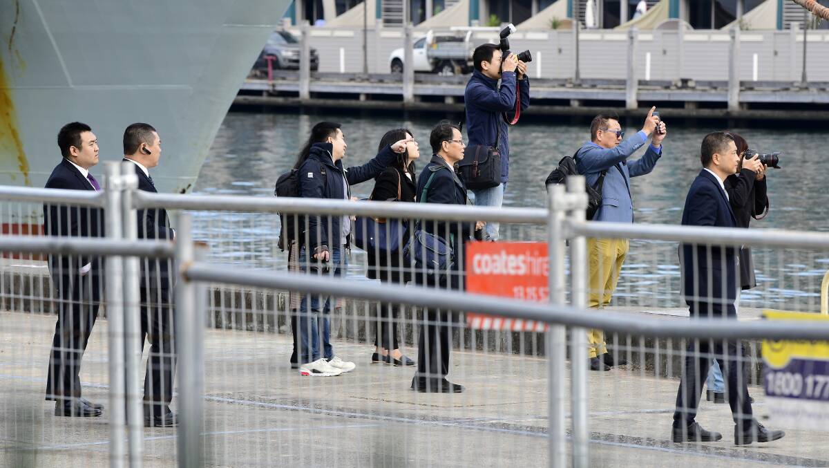 Members of the public take photos as a Chinese ship arrives in Sydney on June 3. Australian Prime Minister Scott Morrison said it was a reciprocal visit after Australian naval vessels visited China. Picture: AAP Image/Bianca De Marchi