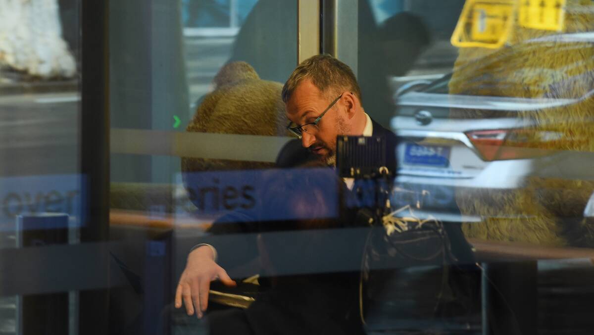 One of three AFP officers sits in the reception of the ABC offices in Ultimo, Sydney. Picture: Kate Geraghty