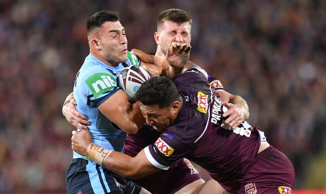 Nick Cotric (left) of the Blues is tackled by Raiders teammate Josh Papalii (centre) and Jai Arrow (right) of the Maroons. Picture: AAP
