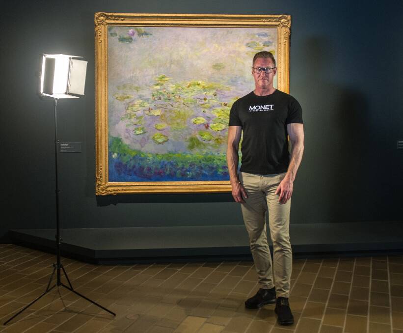 Assistant director of exhibitions and collections Adam Worrall with Monet's Waterlilies. Picture: Karleen Minney