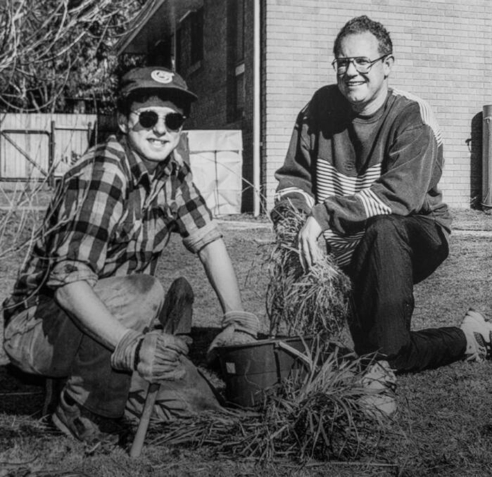 Members of Apex Tuggeranong band together to work on the house and garden of two disabled people in Kambah. Scotty Abela (left) and Mark Quilligan were two of the volunteers. 1996.