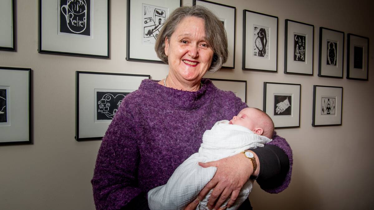 Queen Elizabeth II Family Centre executive director Mary Kirk on Friday with seven-week-old Eryn. Picture: Elesa Kurtz
