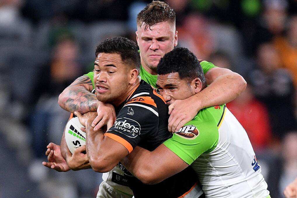 Esan Marsters of the Tigers is tackled by Ryan Sutton (left) and Siliva Havili. Picture: AAP