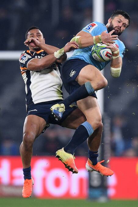 Toni Pulu, left, and Adam Ashley-Cooper compete for a high ball at the new stadium in Parramatta. The Brumbies' win guarantees they will play in the finals this year. Picture: AAP
