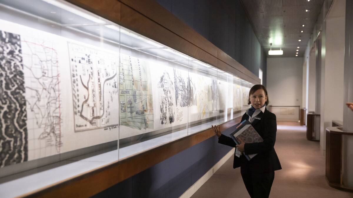 Parliament House visitors' officer Rosie Bruce with some of the embroidery on display. Picture: Sitthixay Ditthavong