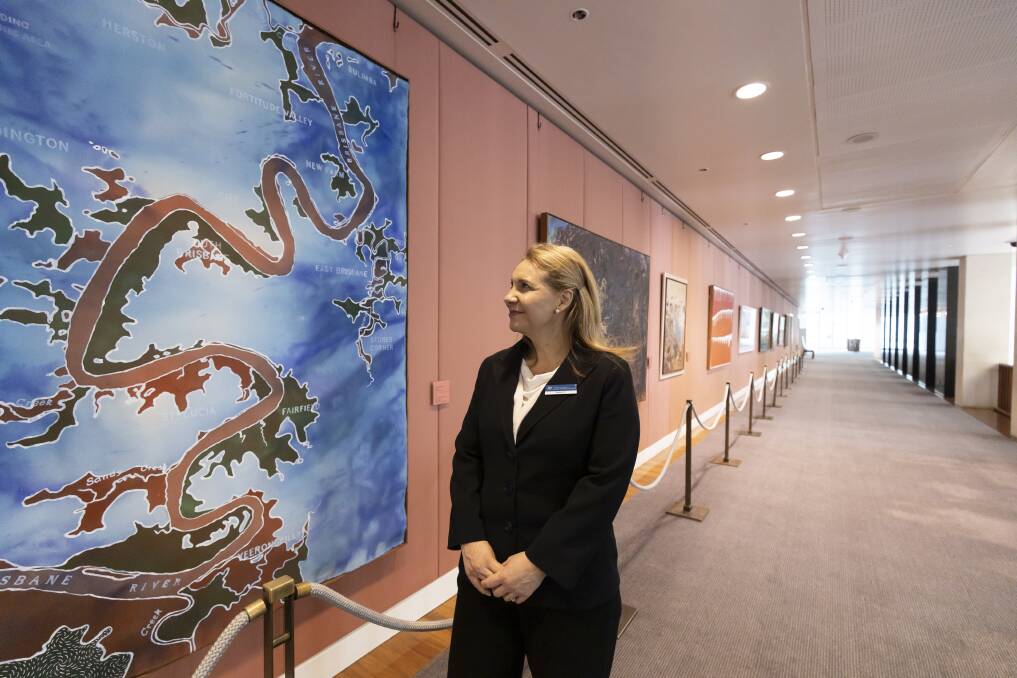 Parliament House visitors' officer Rebekah Eyland with some of the indigenous artwork on display. Picture: Sitthixay Ditthavong