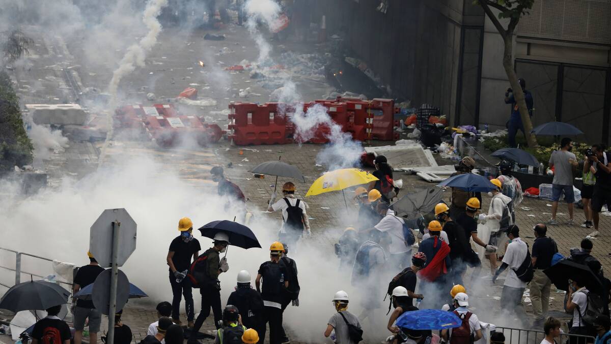 Demonstrators in Hong Kong disperse as the police fire tear gas. Picture: AP