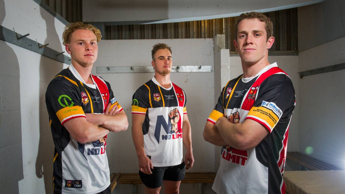 Gungahlin Bulls players Nic Mead, Bradley Scholes and captain Rourke O'Sullivan model the replica jersey of their 1999 premiership that they'll auction off to raise money for Menslink. Picture: Elesa Kurtz