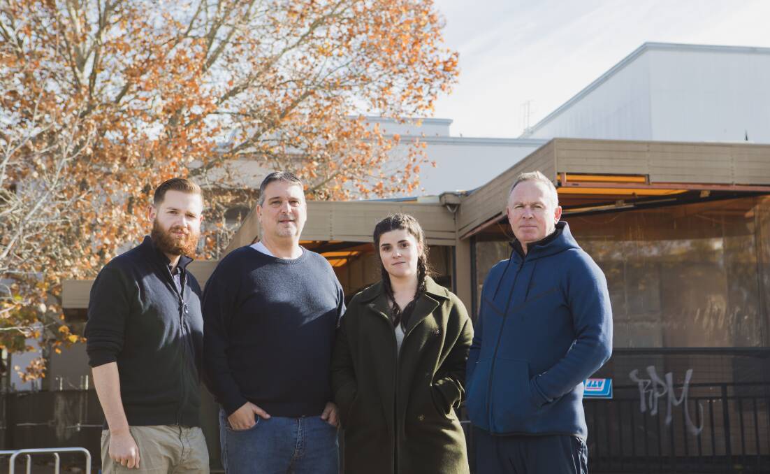 Business owners, from left, John-Paul Romano, who runs the Inner South Canberra Business Council, Caphs Cafe and Bar owner Manuel Notaras, Patissez cafe co-owner Anna Petridis, and Manuka Newsagency owner Matt Nobbs, have signed a letter calling for the tree to be removed. Picture: Jamila Toderas