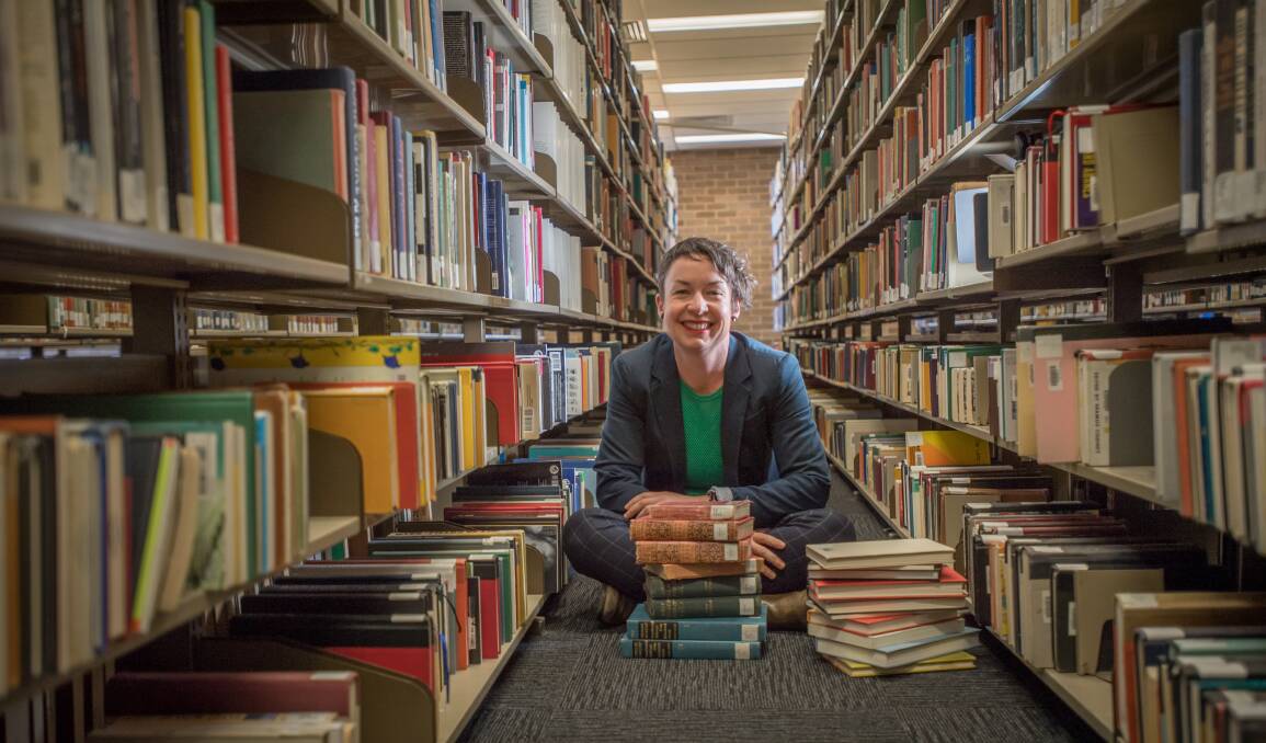 Dr Julieanne Lamond, pictured in the ANU's Chifley Library with some of most popular books identified by the project. Picture: Karleen Minney