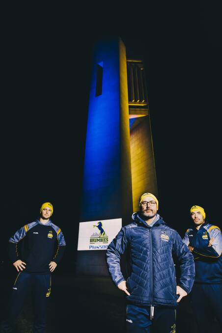 Brumbies stars light up the National Carillon.
From left, Sam Carter, Head coach Dan McKellar, and Rory Arnold.
Picture: Jamila Toderas
