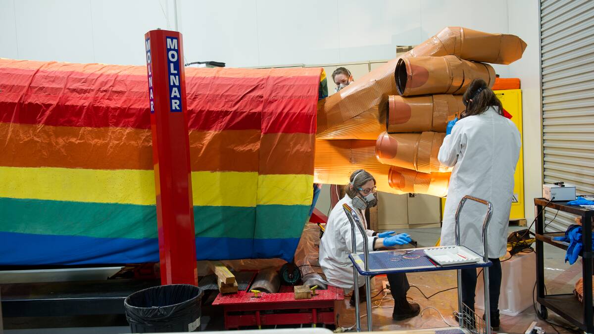 National Museum of Australia conservators prepare the enormous 7-metre anti-war float for its first Canberra appearance in 28 years. Picture: Elesa Kurtz