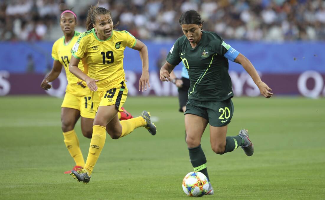 Australia's Sam Kerr, right, scores her side's opening goal during the Women's World Cup Group C match between Jamaica and Australia on June 18. Picture: AP Photo/Laurent Cipriani