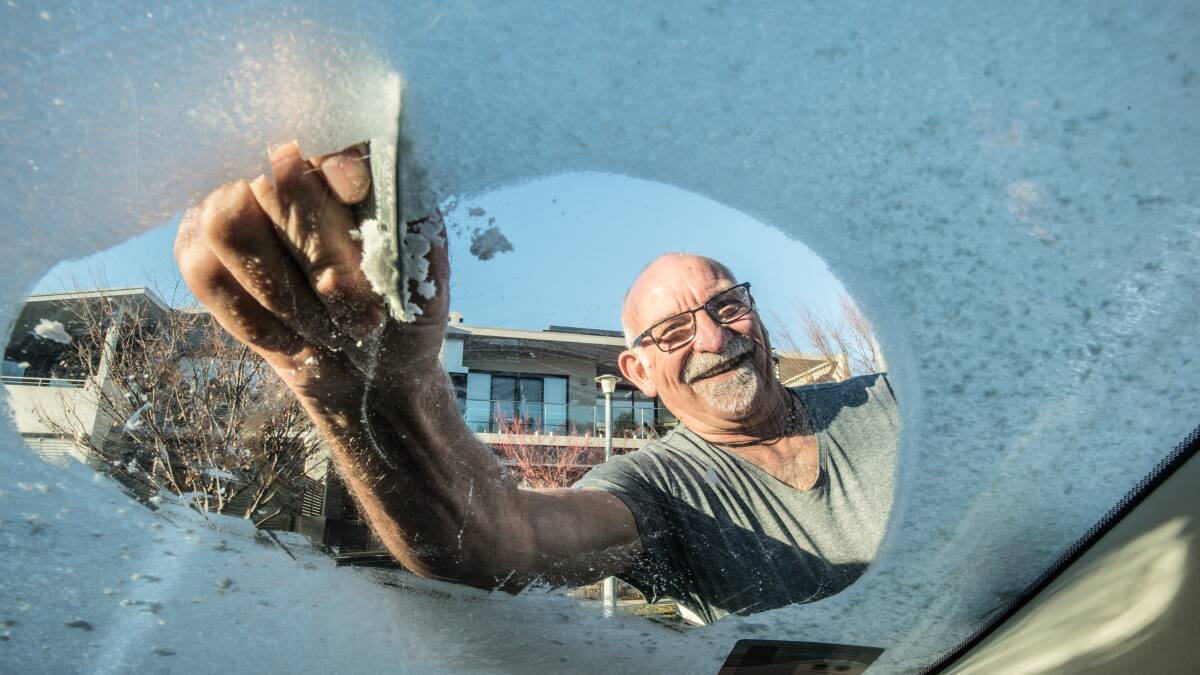 Gary Cairns of Kingston defrosts his windscreen. Picture: Karleen Minney.