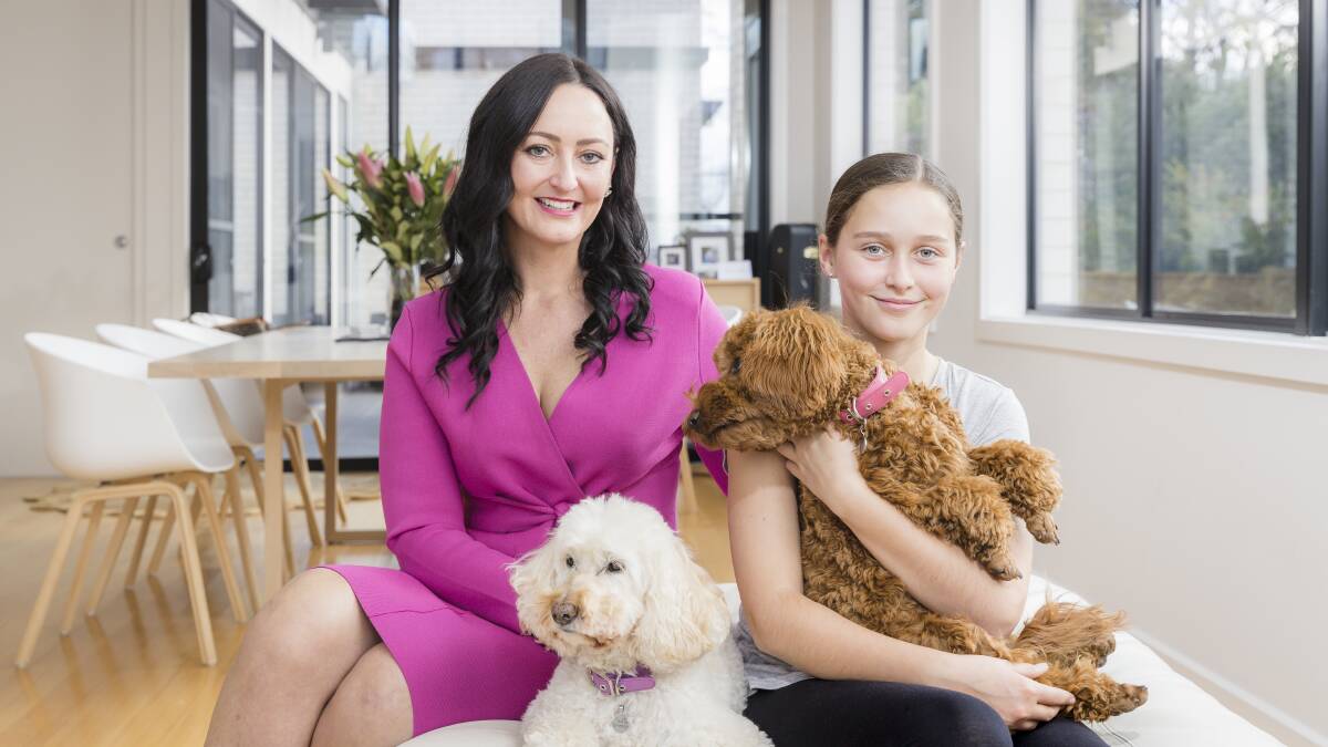 Geocon marketing director Melanie Hindson at home with her daughter Sophie Spilker and spoodles Stella and Gracie. Picture: Sitthixay Ditthavong