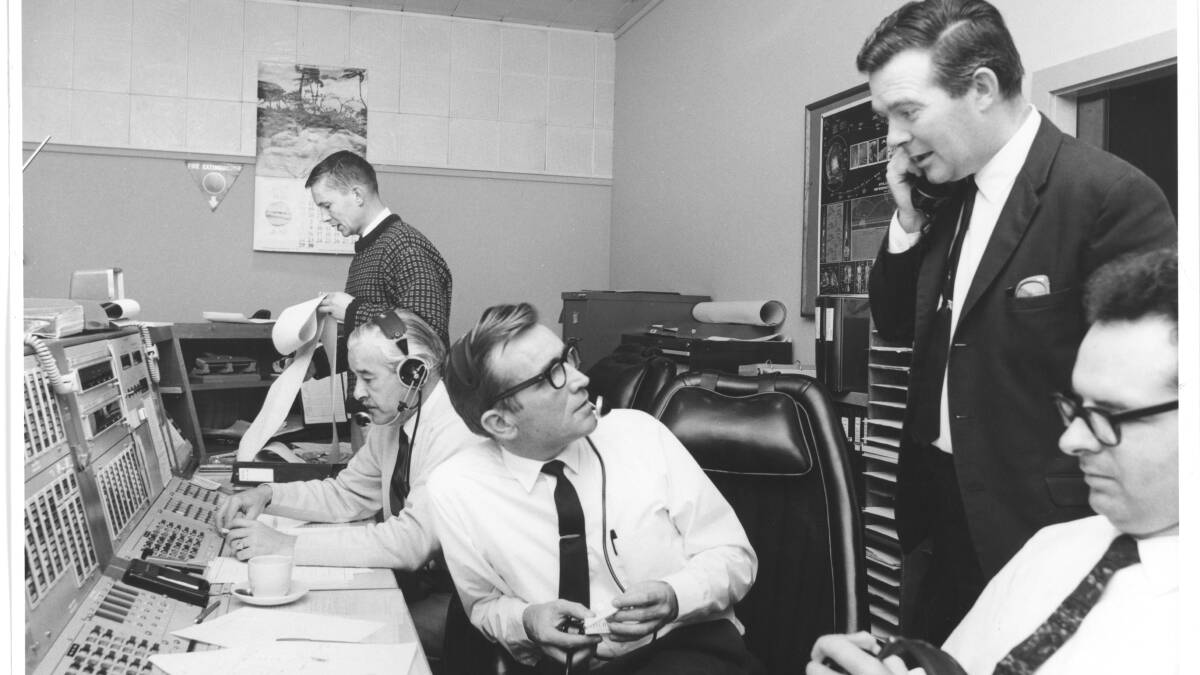 Honeysuckle Creek's Operations Console during preparations for Apollo 11's landing. From left: John Saxon (standing), Ken Lee, Station Director Tom Reid, Mike Dinn, Ian Grant. Picture: Hamish Lindsay and Colin Mackellar