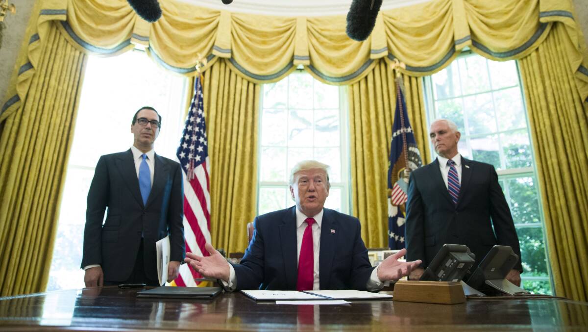 President Donald Trump, with Treasury Secretary Steve Mnuchin, left, and Vice President Mike Pence, during the signing an executive order to increase sanctions on Iran, in the Oval Office. Picture: AP