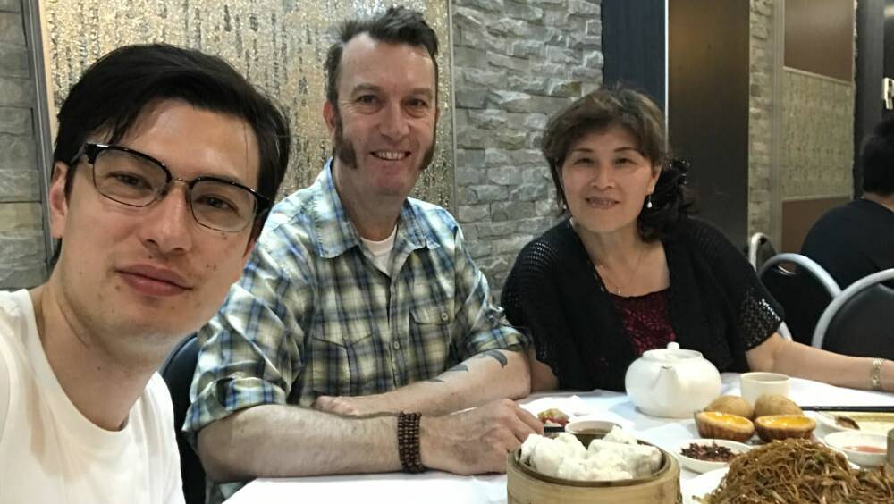 Alek Sigley with his parents in a photo from his blog.