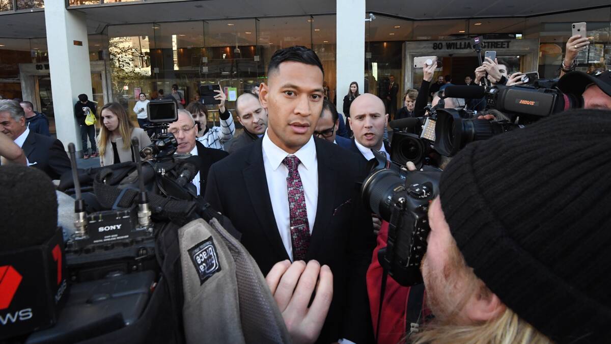 Israel Folau (centre) leaves a conciliation hearing at the Fair Work Commission in Sydney on Friday. Picture: AAP