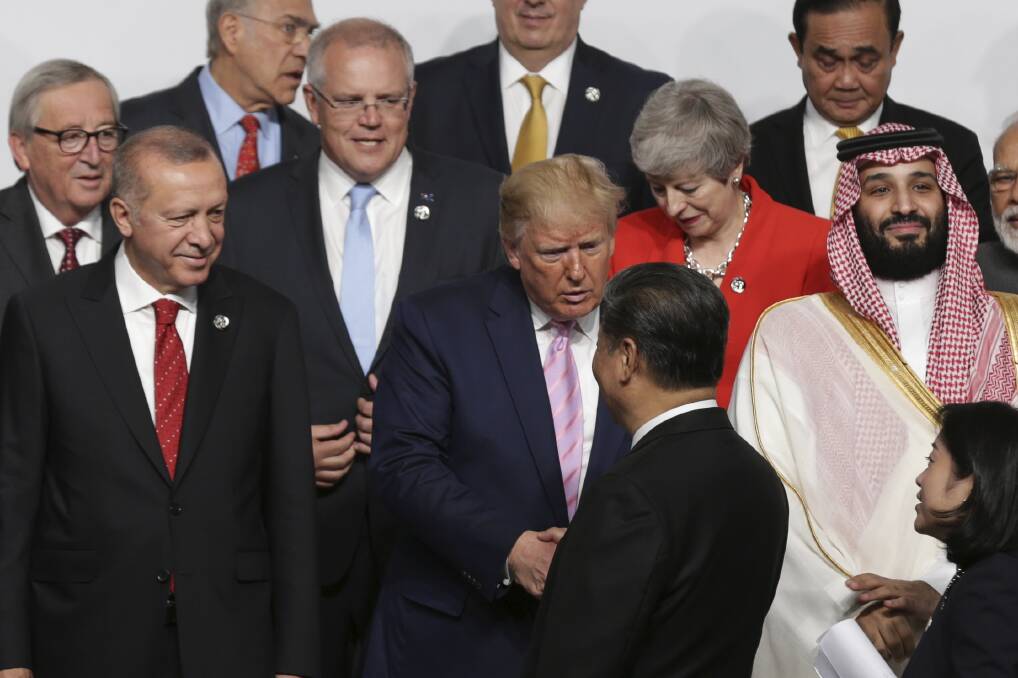Prime Minister Scott Morrison looks on as President of the United States Donald Trump and President of China Xi Jinping shake hands at the G20 Summit in Osaka, Japan. Picture: Alex Ellinghausen