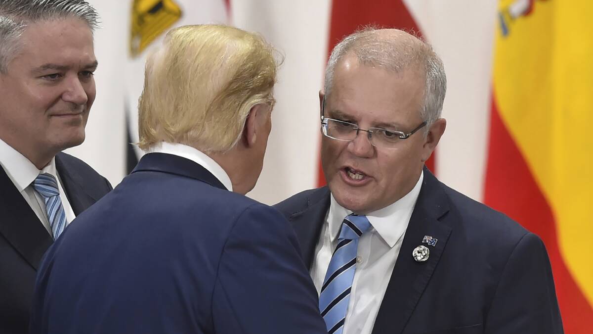 Prime Minister Scott Morrison, right, chats with US President Donald Trump at the G20 summit in Osaka, Japan, on June 29. Picture: Kazuhiro Nogi/AP