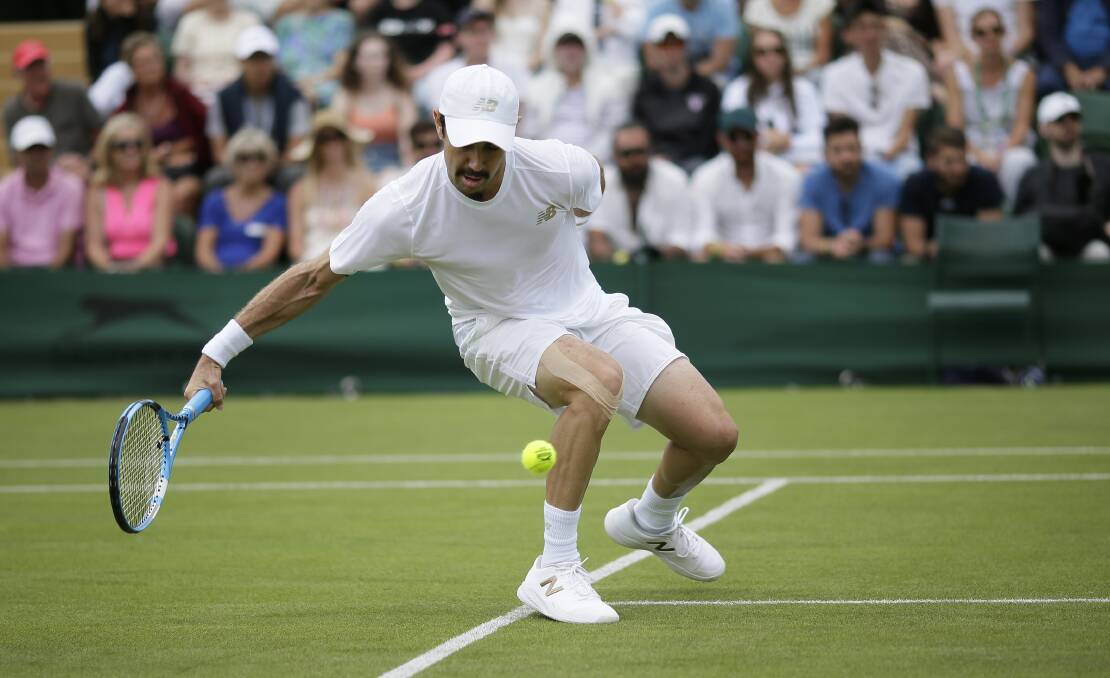 Jordan Thompson reaches back to return to Nick Kyrgios in their Men's singles match at Wimbledon. Picture: AP